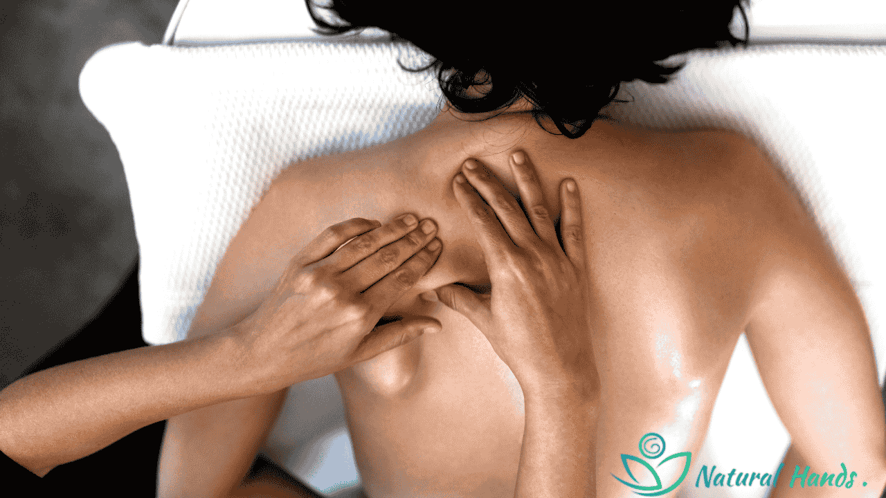 A therapist applying firm pressure during a deep tissue massage to relieve muscle tension.