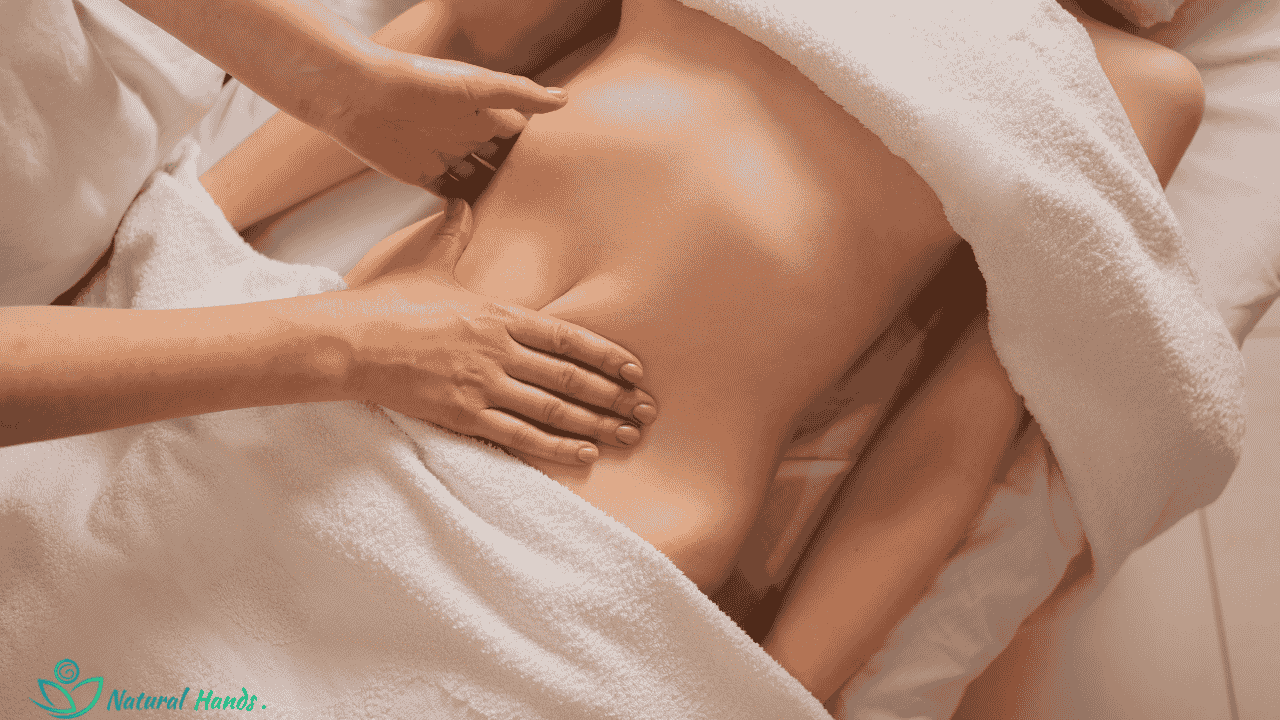 A therapist performing lymphatic drainage massage on a client, using gentle, rhythmic strokes.