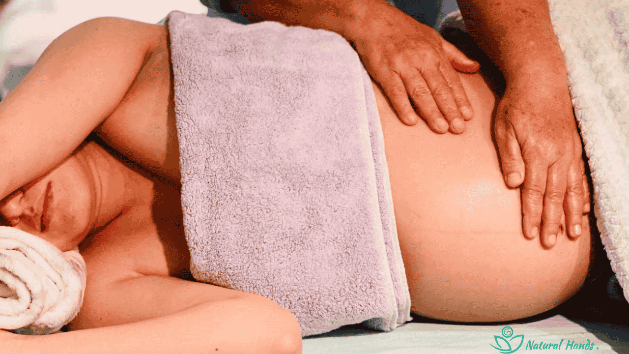 A therapist providing a gentle pre-natal massage to a pregnant client, promoting relaxation and comfort.